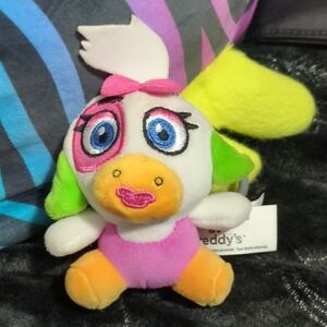Colorful Plush Toy with Pink and Green Accents